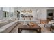 Inviting living room with a large sectional sofa, modern decor, and open layout to the kitchen at 2616 Tolmezzo St, Henderson, NV 89044