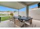 Covered patio with an outdoor dining set overlooking a pool and backyard at 2616 Tolmezzo St, Henderson, NV 89044