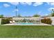 Sparkling backyard pool and spa with lounge chairs, striped umbrella, and privacy wall with climbing vines at 2616 Tolmezzo St, Henderson, NV 89044