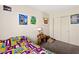 Well-lit bedroom featuring sports-themed decor, carpeted flooring, and a closet at 2664 Strichen Ave, Henderson, NV 89044