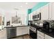 Well-lit kitchen featuring stainless steel appliances, ample countertop space, and white cabinetry at 2664 Strichen Ave, Henderson, NV 89044