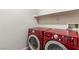 Laundry room with modern, red washer and dryer at 2664 Strichen Ave, Henderson, NV 89044