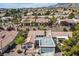 Expansive aerial shot of a suburban neighborhood with lush trees and tiled roofs at 2913 Laverton Dr, Las Vegas, NV 89134