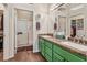 Bathroom featuring double sinks, granite countertops, and a glass enclosed shower at 2913 Laverton Dr, Las Vegas, NV 89134