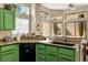 The kitchen features green cabinets, granite countertops, and stainless steel dishwasher at 2913 Laverton Dr, Las Vegas, NV 89134