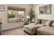 Comfortable living room with couch, ottoman, and large window with decorative blinds at 2913 Laverton Dr, Las Vegas, NV 89134