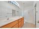 Bathroom features a double sink vanity, a full-width mirror with stylish lighting, and a glass-enclosed shower at 3036 Monroe Park Rd, Henderson, NV 89052