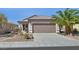 Charming single-story home with a landscaped front yard and two-car garage at 3036 Monroe Park Rd, Henderson, NV 89052