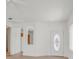 Welcoming living room with a decorative front door and view into kitchen at 3036 Monroe Park Rd, Henderson, NV 89052