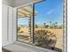 A window showcases a backyard with gravel landscaping, a covered patio, and scenic mountain views in the distance at 3036 Monroe Park Rd, Henderson, NV 89052