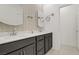 Modern bathroom featuring double sinks, a vanity with cabinets, mirrors and modern fixtures at 333 Aravalli Crest St, Henderson, NV 89015