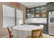 Charming dining area with a round table, four chairs, bright natural light, and stylish kitchen cabinetry at 333 Aravalli Crest St, Henderson, NV 89015