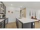 Modern kitchen view highlighting the island, stainless steel appliances, and convenient access to other rooms at 333 Aravalli Crest St, Henderson, NV 89015