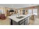 Bright, open kitchen with stainless steel sink and island, flowing into the living area at 333 Aravalli Crest St, Henderson, NV 89015