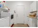 Well-lit laundry area with modern washer, dryer, and convenient storage cabinets at 333 Aravalli Crest St, Henderson, NV 89015
