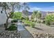 Serene community grounds with lush landscaping and walking paths; mountain views in background at 3457 Abilene Gold Ct, Las Vegas, NV 89129