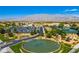 Panoramic aerial showcasing lush landscaping, pond, parking and mountain views in the community at 3520 Kittiwake Rd, North Las Vegas, NV 89084