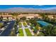 Overhead view of neighborhood amenities: lawn bowling, tennis courts, landscaping, and clubhouse at 3520 Kittiwake Rd, North Las Vegas, NV 89084