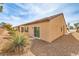 Back of the house view features rock ground cover, stucco walls, and patio at 3520 Kittiwake Rd, North Las Vegas, NV 89084