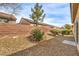 Low maintenance backyard with rock ground cover, brick wall and minimal landscaping at 3520 Kittiwake Rd, North Las Vegas, NV 89084