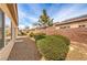 Backyard view with a brick wall, stucco exterior, and some shrubbery at 3520 Kittiwake Rd, North Las Vegas, NV 89084