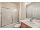 Clean bathroom with shower-tub combo, standard vanity, and large mirror at 3520 Kittiwake Rd, North Las Vegas, NV 89084