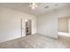 A bright, carpeted bedroom featuring a ceiling fan, with an ensuite bathroom and walk-in closet at 3520 Kittiwake Rd, North Las Vegas, NV 89084