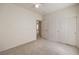A carpeted bedroom with a ceiling fan and doors to the closet and hallway at 3520 Kittiwake Rd, North Las Vegas, NV 89084