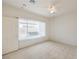 Bedroom features neutral carpet, window with blinds, and bright natural light at 3520 Kittiwake Rd, North Las Vegas, NV 89084