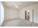 Bright bedroom with neutral carpet, a ceiling fan and an ensuite bathroom and walk-in closet at 3520 Kittiwake Rd, North Las Vegas, NV 89084