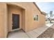 Inviting entryway with a classic black door and a side window allowing natural light in at 3520 Kittiwake Rd, North Las Vegas, NV 89084