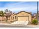Charming single-story home featuring desert landscaping, a two-car garage, and a neutral color scheme at 3520 Kittiwake Rd, North Las Vegas, NV 89084