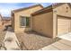 Close up view of a house with a two-car garage and desert landscaping in the front yard at 3520 Kittiwake Rd, North Las Vegas, NV 89084