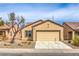 Charming single-story home featuring desert landscaping, a two-car garage, and a neutral color scheme at 3520 Kittiwake Rd, North Las Vegas, NV 89084