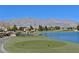 Scenic golf course with a pond, mountains, and clear blue sky backdrop at 3520 Kittiwake Rd, North Las Vegas, NV 89084