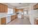 Kitchen boasts tile flooring, wood cabinets, and views to the living area at 3520 Kittiwake Rd, North Las Vegas, NV 89084