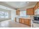 Functional kitchen features tile floors, wood cabinets, and modern appliances at 3520 Kittiwake Rd, North Las Vegas, NV 89084