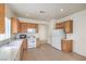 Practical kitchen showcases tile floors and efficient appliances for cooking at 3520 Kittiwake Rd, North Las Vegas, NV 89084