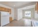 Bright kitchen boasts tile flooring, a window, and a full-size refrigerator at 3520 Kittiwake Rd, North Las Vegas, NV 89084