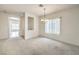 Open living space features neutral carpet, a chandelier, and an open floor plan at 3520 Kittiwake Rd, North Las Vegas, NV 89084