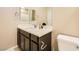 Full bathroom showcases dark cabinetry, quartz countertops, and modern fixtures at 39 Strada Fontana, Henderson, NV 89011