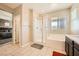 Bathroom with a bathtub, glass shower, and access to the bedroom, ideal for a seamless morning routine at 39 Strada Fontana, Henderson, NV 89011