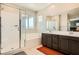 Bright bathroom featuring dual sinks, a soaking tub, and a glass-enclosed shower for a spa-like experience at 39 Strada Fontana, Henderson, NV 89011