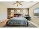 This expansive bedroom features a ceiling fan and a workspace, all complemented by a striking accent wall at 39 Strada Fontana, Henderson, NV 89011