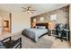 Bedroom with a textured accent wall, ceiling fan, and workspace, perfect for relaxation and productivity at 39 Strada Fontana, Henderson, NV 89011