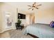 Inviting bedroom with a cozy chair, television, and access to a balcony for enjoying the outdoors at 39 Strada Fontana, Henderson, NV 89011