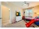 Bright bedroom features a ceiling fan, window with blinds, and playful decor for a  at 39 Strada Fontana, Henderson, NV 89011