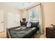 Comfortable bedroom featuring a ceiling fan, large window, closet, and neutral decor at 39 Strada Fontana, Henderson, NV 89011