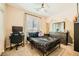Comfortable bedroom with a ceiling fan, large window, a workstation, and modern decor at 39 Strada Fontana, Henderson, NV 89011
