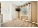 Neutral bedroom with a window, mounted TV and plush carpeting at 39 Strada Fontana, Henderson, NV 89011